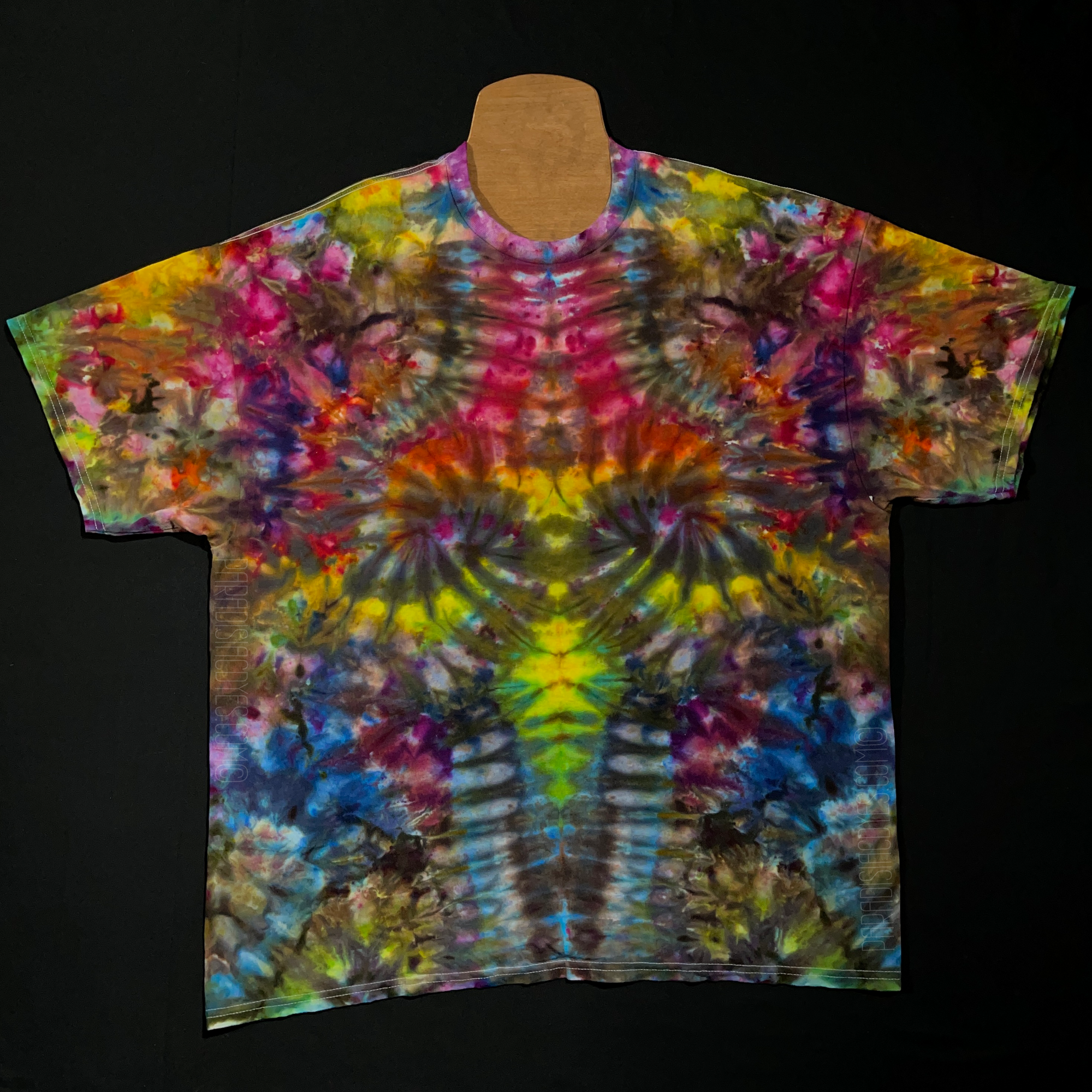 Front side of a size xxl psychedelic mindscape ice tie-dyed short sleeve shirt design that features a vibrant array of rainbow colors throughout the totem pole reminiscent pattern