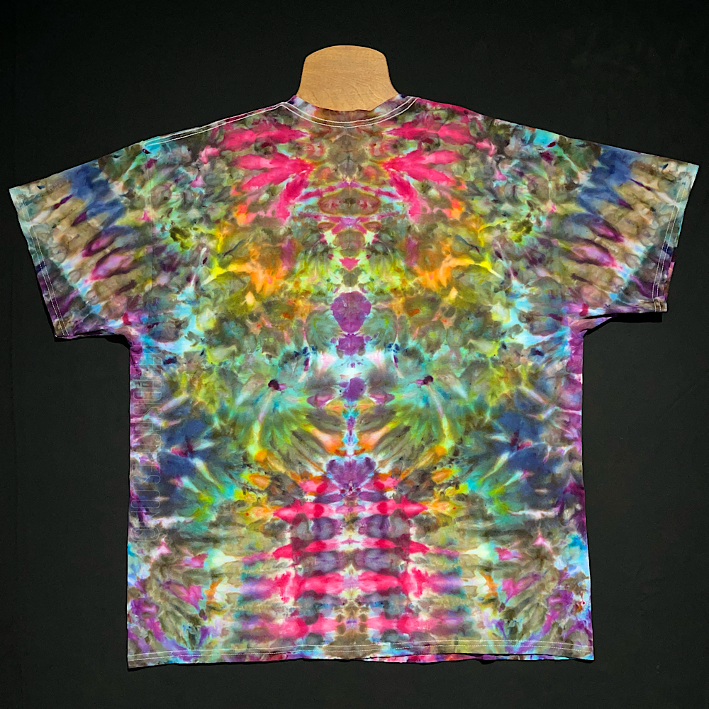 Front side of a rainbow Psychedelic Mindscape abstract, symmetrical ice tie-dyed t-shirt design; laid flat on a solid black background.