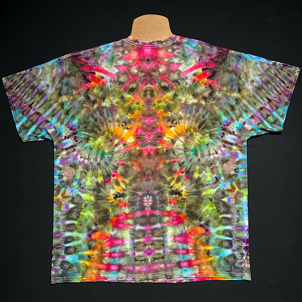 Front side of a one-of-a-kind, abstract, rainbow ice tie-dyed t-shirt design; laid flat on a solid black background.