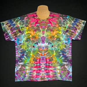 Front side of a rainbow Psychedelic Mindscape abstract, symmetrical ice tie-dyed t-shirt design; laid flat on a solid black background.