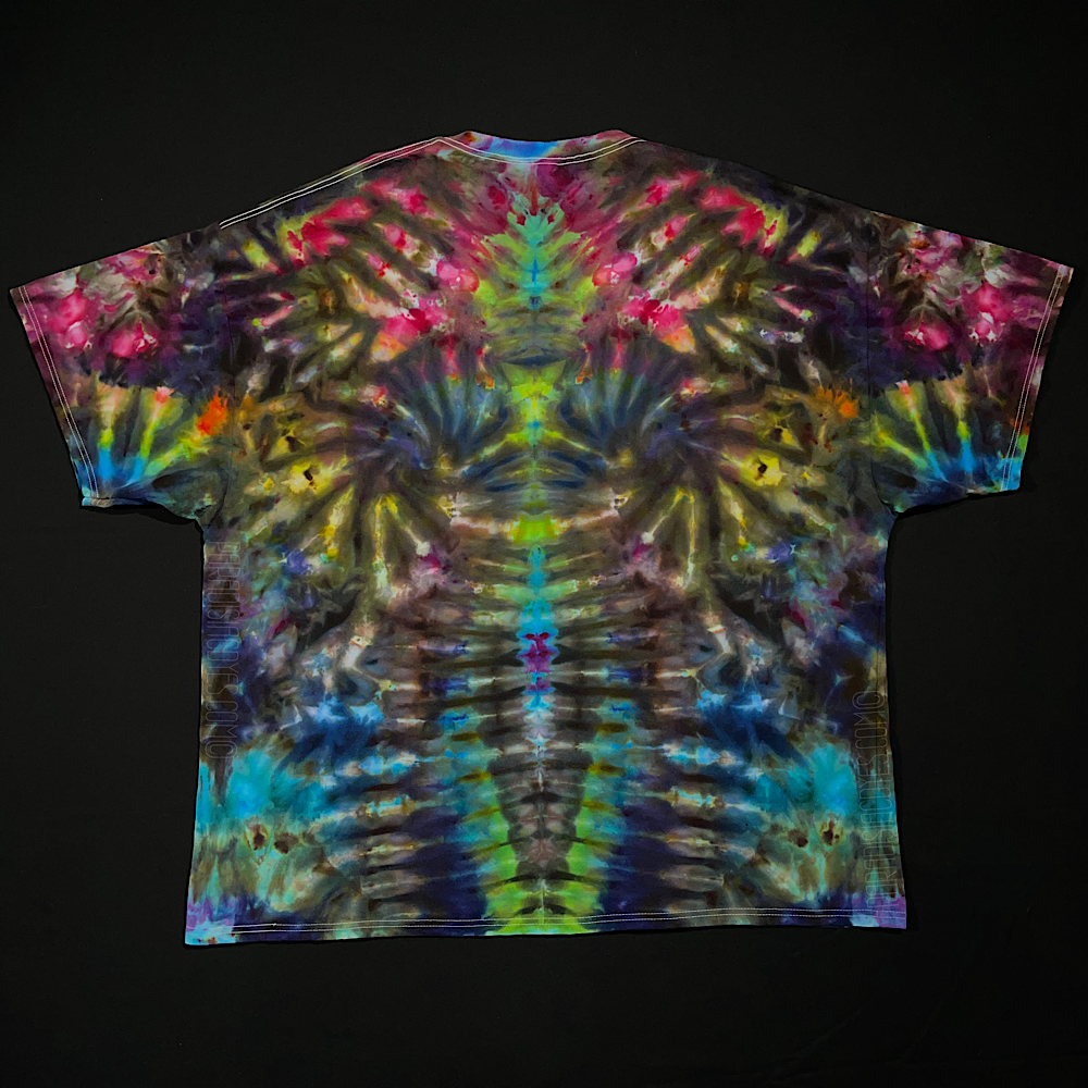 Front side of a vibrant rainbow Psychedelic Mindscape ice tie-dyed short sleeve shirt, featuring: hot fuchsia pink, orange, yellow, green & blue shades; laid flat on a solid black background