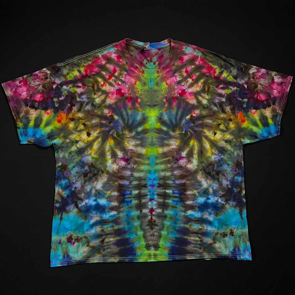 Front side of a vibrant rainbow Psychedelic Mindscape ice tie-dyed short sleeve shirt, featuring: hot fuchsia pink, orange, yellow, green & blue shades; laid flat on a solid black background