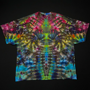 Front side of a vibrant rainbow Psychedelic Mindscape ice tie-dyed short sleeve shirt, featuring: hot fuchsia pink, orange, yellow, green & blue shades; laid flat on a solid black background