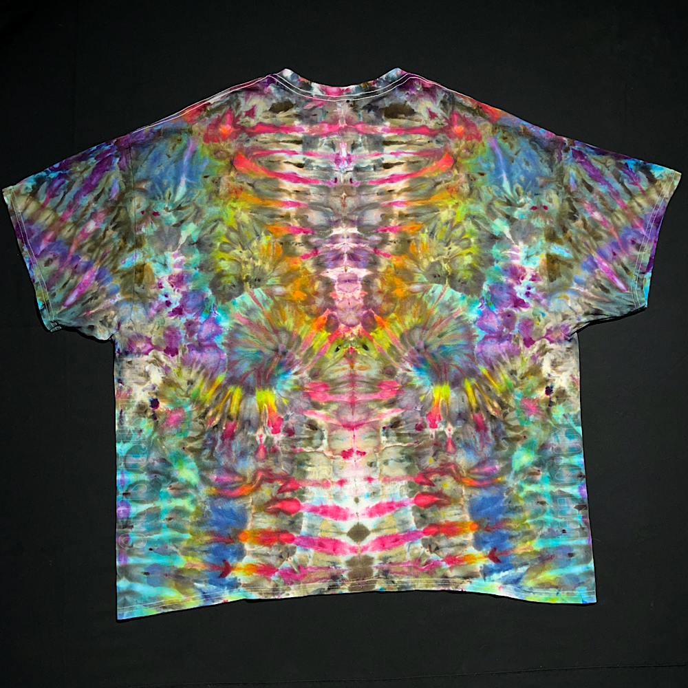 Front side of a rainbow colored abstract, symmetrical Psychedelic Mindscape ice tie-dyed short sleeve shirt design; laid flat on a solid black background.