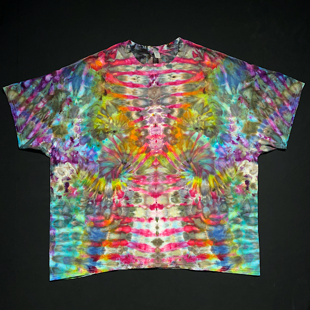 Front side of a rainbow colored abstract, symmetrical Psychedelic Mindscape ice tie-dyed short sleeve shirt design; laid flat on a solid black background.