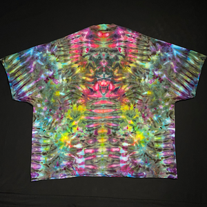 Back side of a hand-dyed, one-of-a-kind, abstract, symmetrical Psychedelic Mindscape ice tie-dyed design featuring vibrant rainbow colors; laid flat on a solid black background.