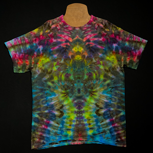 Front side of an adult large vibrant rainbow abstract, symmetrical ice tie-dyed t-shirt design; laid flat on a solid black background 