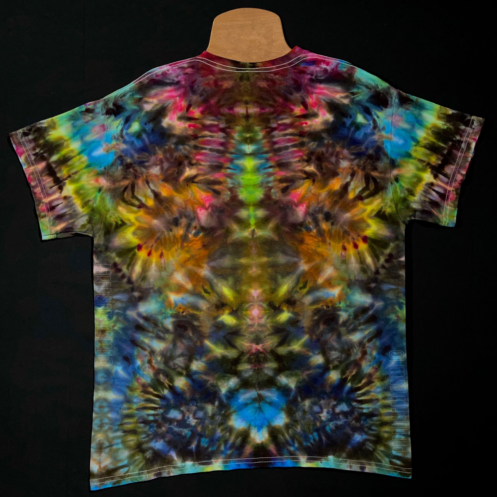 Back side of the same neon rainbow psychedelic mindscape ice dye design; laid flat on a solid black background