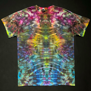 Front side of an abstract, symmetrical Psychedelic Mindscape ice tie-dyed design featuring a dull, muddy, rainbow color scheme; laid flat on a solid black background.