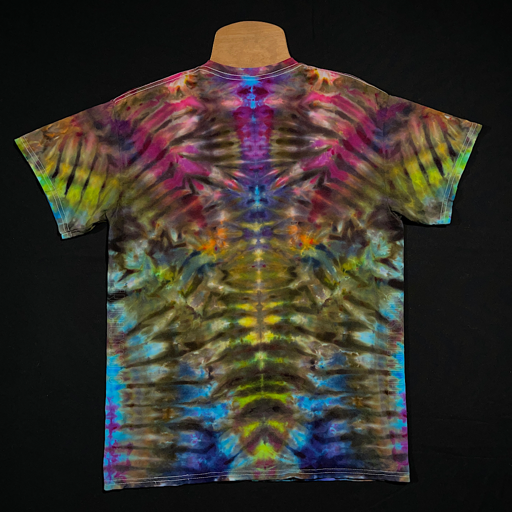 Back side of the same vibrant, tropical rainbow Psychedelic Mindscape short sleeve ice tie-dyed t-shirt design; laid flat on a solid black background