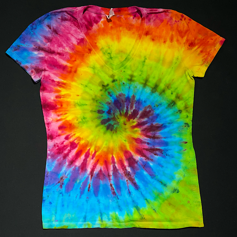 Front side of a neon rainbow spiral ice tie-dyed women's v-neck style t-shirt, laid flat on a solid black background.