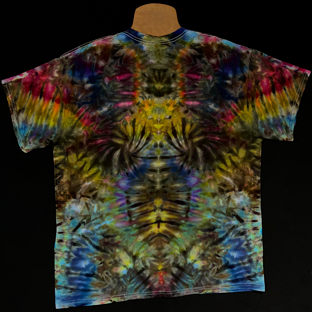 Front side of an abstract, symmetrical, Psychedelic Mindscape ice tie-dyed shirt design featuring a dark rainbow color scheme; laid flat on a solid black background.