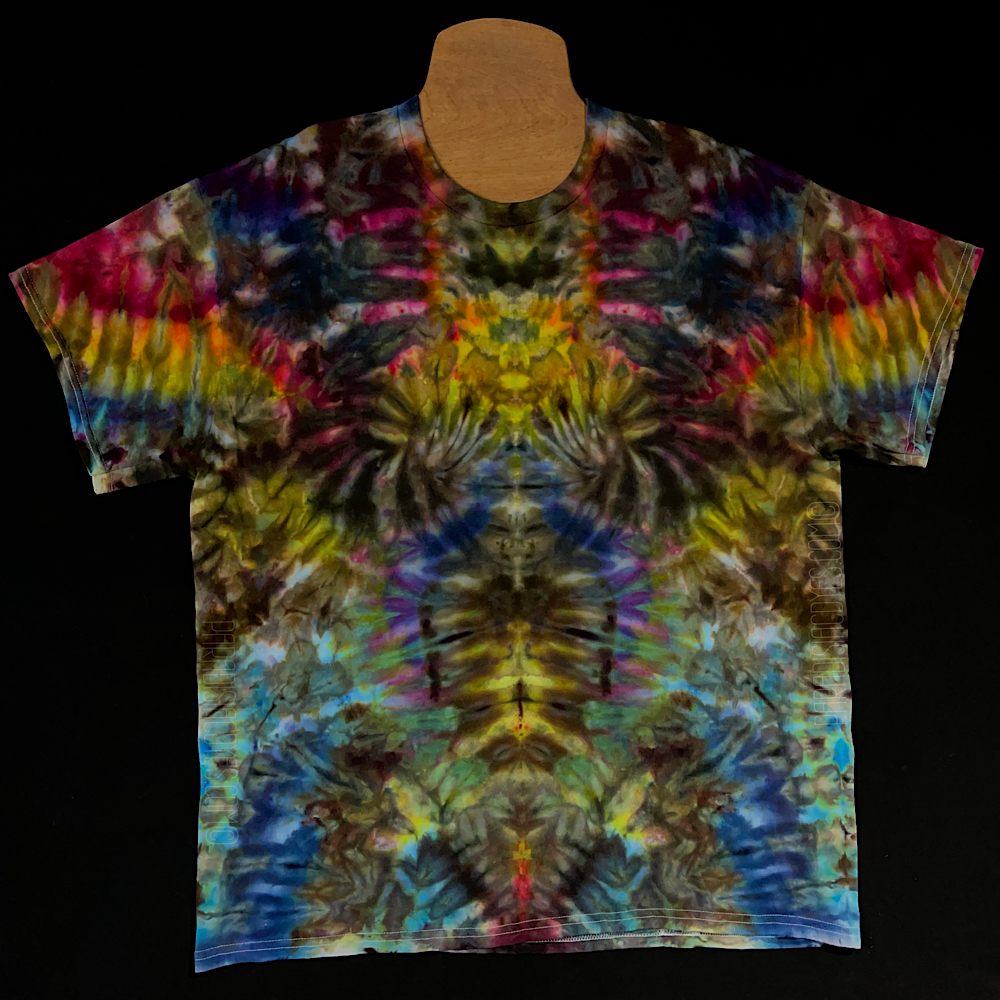 Front side of an abstract, symmetrical, Psychedelic Mindscape ice tie-dyed shirt design featuring a dark rainbow color scheme; laid flat on a solid black background.