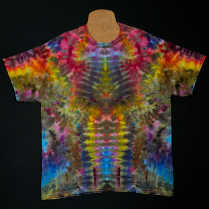 Front side of an abstract, symmetrical ice tie-dyed psychedelic mindscape short sleeve shirt design; featuring a cascading gradient of rainbow colors from top to bottom in a totem pole reminiscent pattern