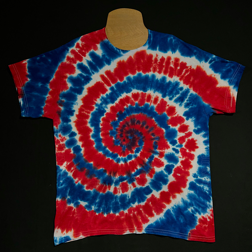 Another example of a different Red, White & Blue spiral tie dye shirt; laid flat on a solid black background