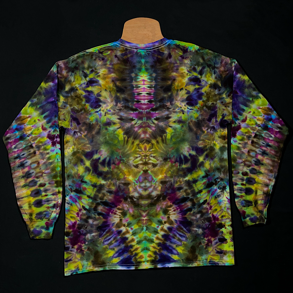 The back side of a handmade-to-order Psychedelic Mindscape ice dye long sleeve shirt design in a Halloween themed green & purple color scheme in an abstract, symmetrical, totem pole reminiscent pattern