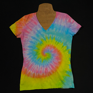 Front side of a pastel rainbow spiral tie dye v-neck t-shirt, laid flat on a solid black background 