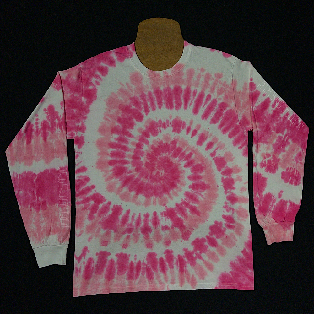 An example of a finished Bubblegum pink spiral long sleeve tie dye shirt; laid flat on a solid black background 