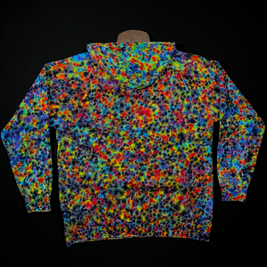 Back side of a pullover style tie dyed hoodie featuring vibrant rainbow colors in a paint splatter reminiscent, speckled design