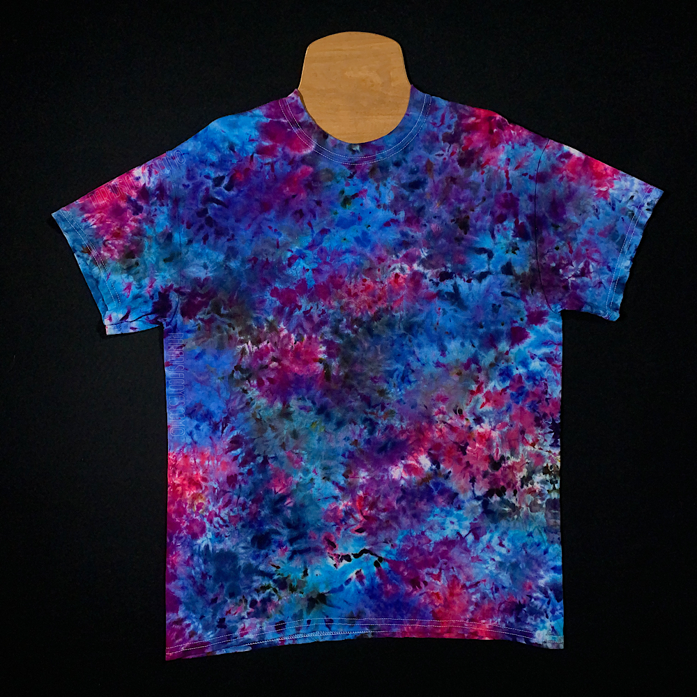 Front side of a cloud 9 marbled ice dye t-shirt, a blue, pink and purple splatter pattern