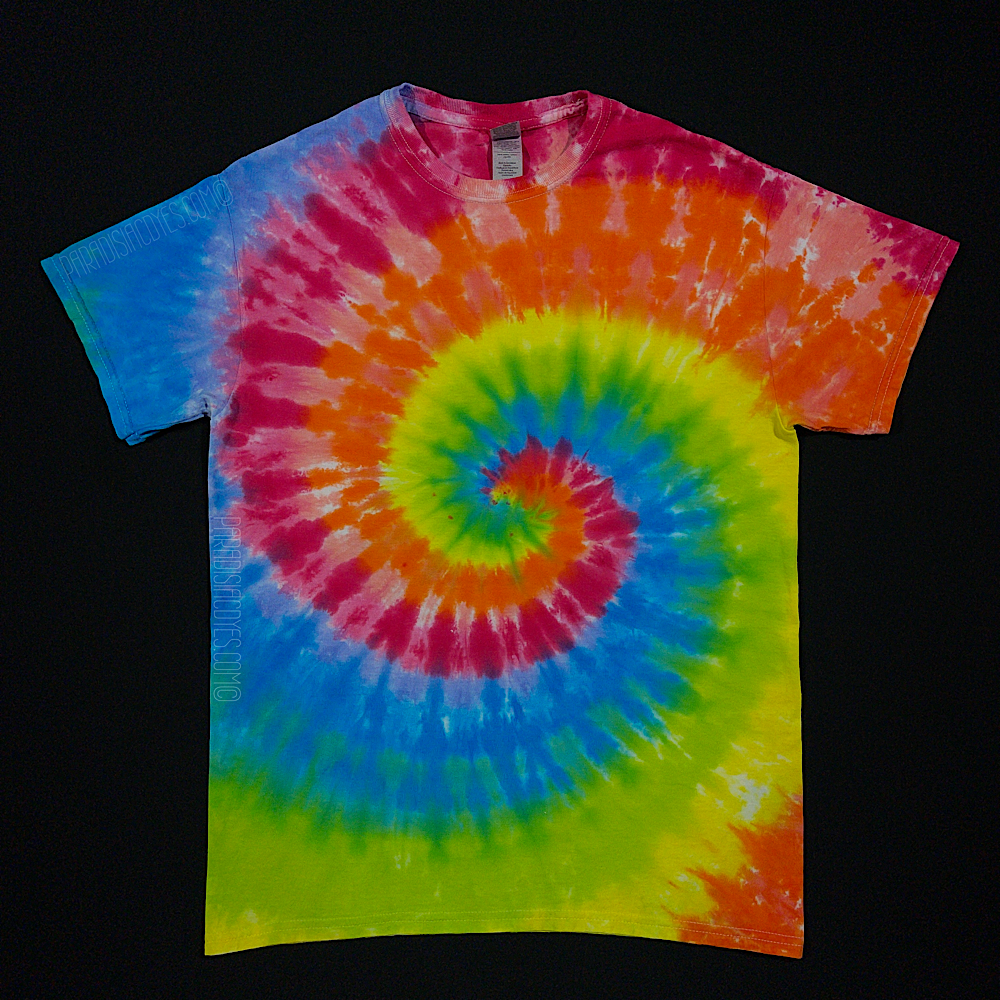 A toddler sized short sleeve t-shirt featuring a vibrant neon rainbow spiral design; laid flat on a solid black background 