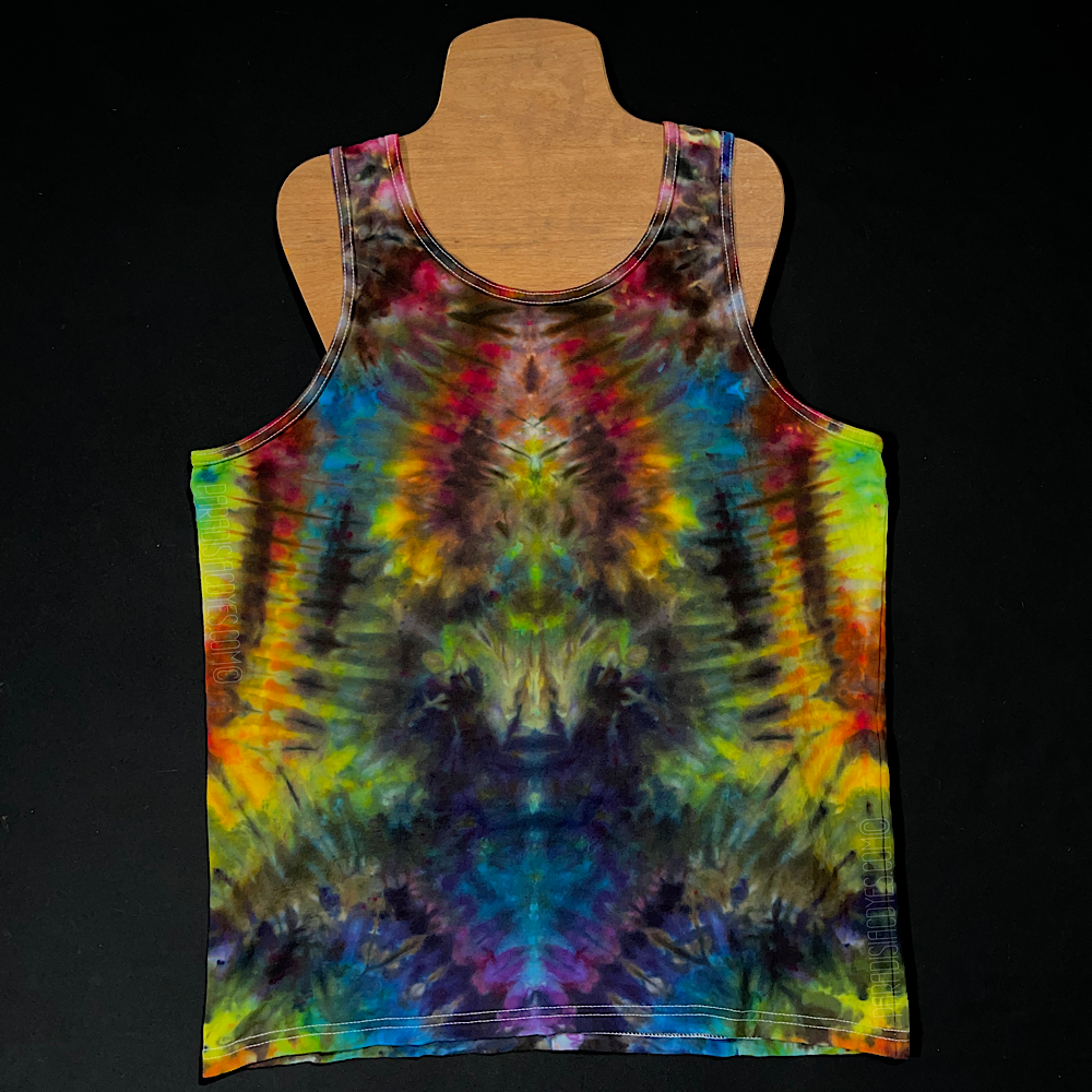 Front side of a size men's large Gildan tank top featuring a handmade, one of a kind rainbow ice dyed design in an abstract, symmetrical pattern; laid flat on a solid black background 