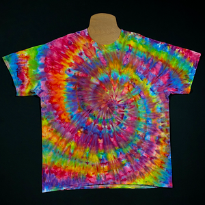 Front side of a rainbow confetti spiral ice dyed design on a short sleeve, crewneck style Gildan Ultra Cotton t-shirt. Each handmade-to-order tie dye shirt design comes out totally unique and is genuienly one of a kind.