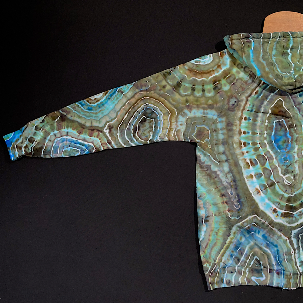 Back side of the left arm sleeve of the size large earthy, blue agate geode ice dye zip-up hoodie, fully extended to showcase the entirety of the unique back side of the sleeve design