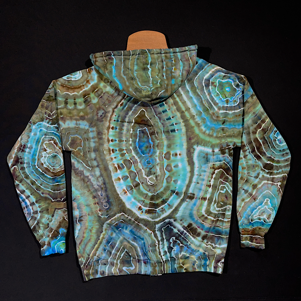 Back side of the size large tie dye zip-up hoodie featuring an agate geode inspired ice dyed design with shades of blue with earthy taupe browns and mossy greens