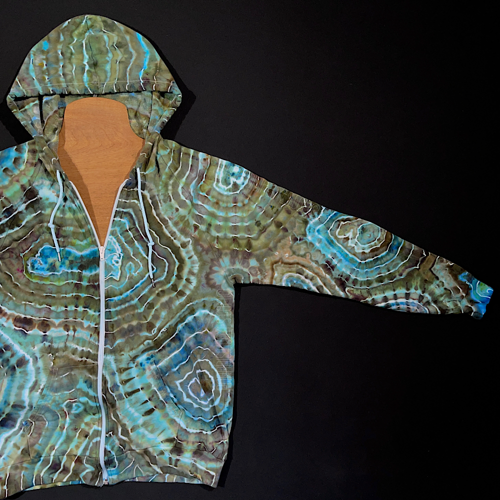 Front side of the left sleeve of the earthy blue agate geode ice dye zip-up hoodie, fully extended to showcase the entirety of the front side of the sleeves unique, one of a kind design