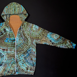 Front side of the left sleeve of the earthy blue agate geode ice dye zip-up hoodie, fully extended to showcase the entirety of the front side of the sleeves unique, one of a kind design