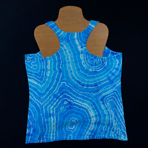 Back side of a size large ladies' racerback style tank top in an agate geode ice dyed design with vibrant, dreamy trii-toned blend of light sky and ocean blues