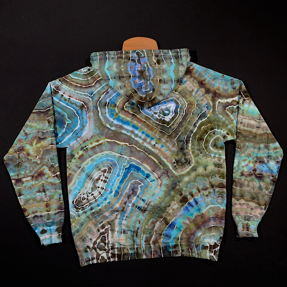 Front side of a size adult XL pullover tie dye hoodie featuring an agate geode inspired ice dye design with earthy, rustic shades contrasted by highlights of cool blues