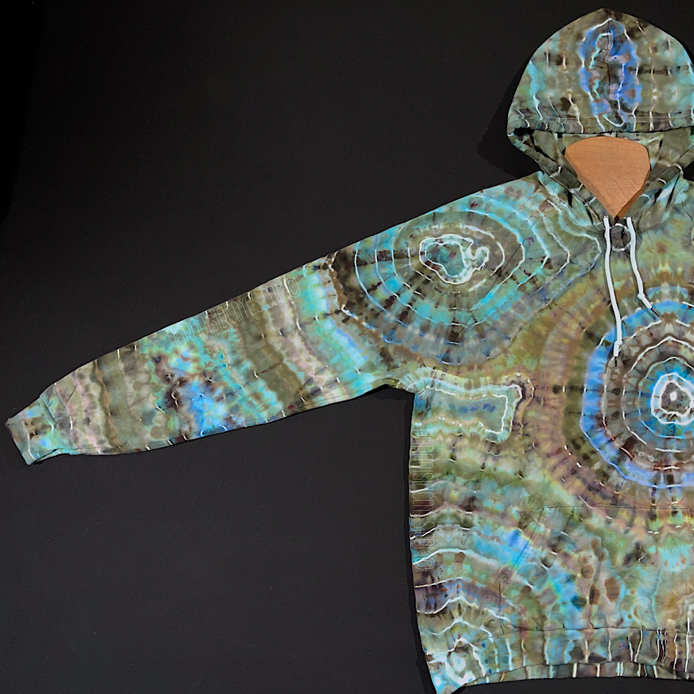 The fully extended front right side sleeve of the size xl pullover hoodie in a one of a kind geode ice dye design