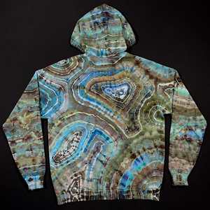 Back side of the adult XL pullover hoodie featuring an earthy, blue agate geode ice dyed design. Displayed with the hood up, to showcase the back side of the hood's design