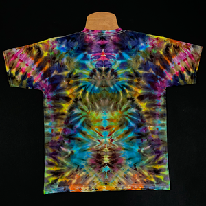 The back side of the same children's short sleeve tie dye shirt featuring a multitude of vibrant rainbow colors in an abstract, symmetrical ice dyed design