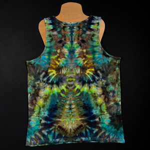 Back side of a men's large tank top featuring a cool blend of blue, green & earthy brown shades in an abstract, symmetrical, pareidolia inducing ice tie dyed design; displayed on a t-shirt mannequin on a solid black background