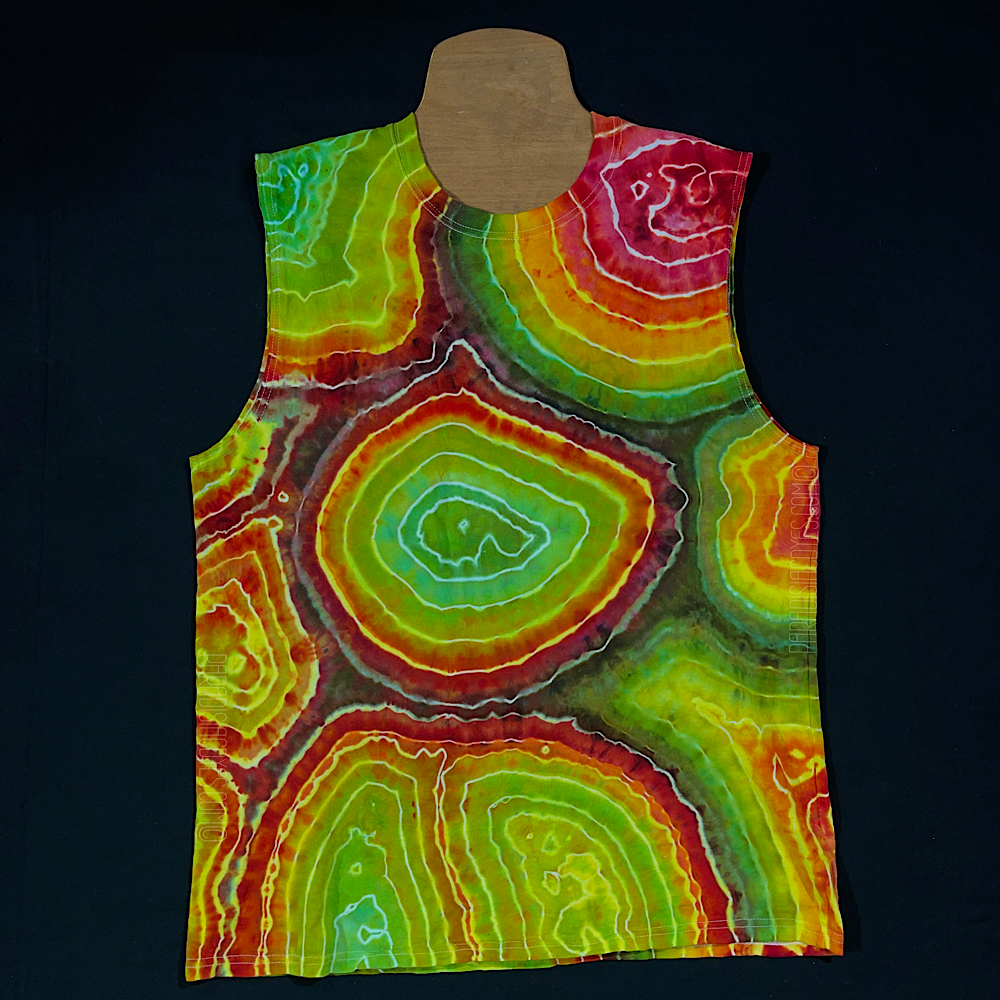 Front side of a size men's large muscle style tank top in a rasta colored (red, yellow & green) agate geode ice dyed design, laid flat on a solid black background 