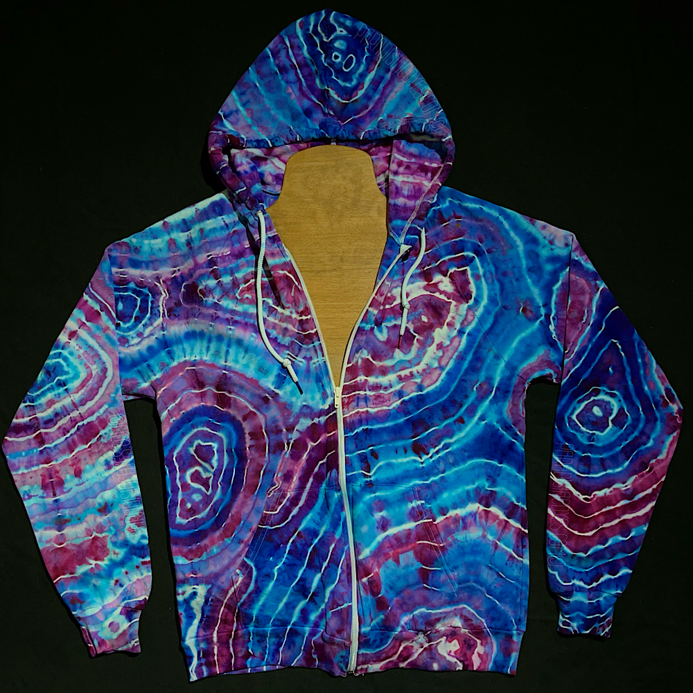 Front side of a size adult medium zip up hooded sweatshirt featuring a hand-dyed, one of a kind agate geode reminiscent ice tie dyed design with a totally different pattern on each side, in a dreamy cotton candy color scheme